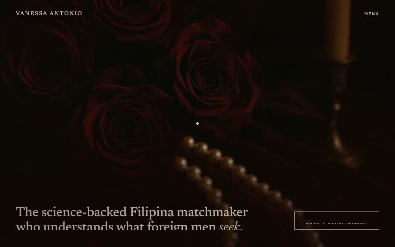 The concept site's hero still: dark red roses, a strand of pearls, and a candlestick in candlelight, with the headline in champagne-gold serif and a framed Book A Consultation slate at bottom right
